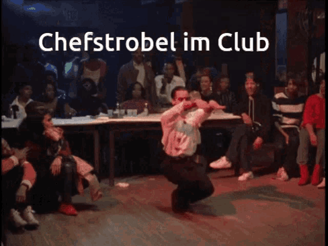 a man is dancing in front of a crowd and the caption chefstrobel im club is above him