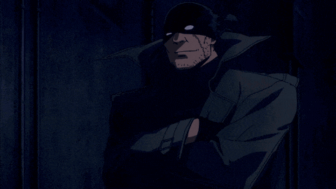 a man with a beard wearing a black mask and a black coat