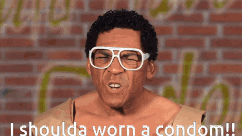 a man wearing glasses and a cardboard box says i shoulda worn a condom