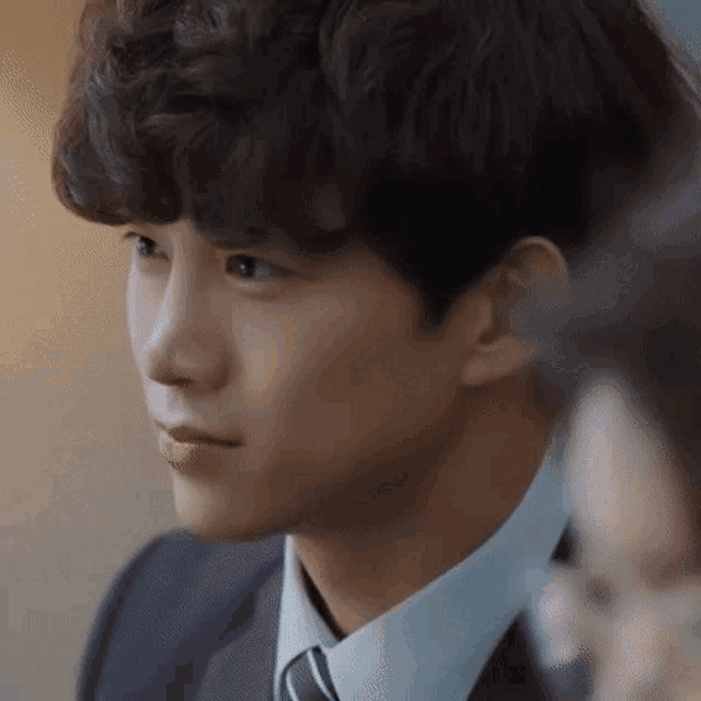 a man in a suit and tie is looking at a woman .