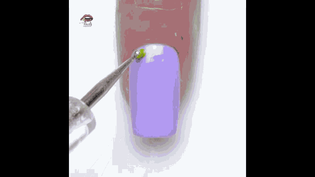 a close up of a person 's nails with purple nail polish and a brush .
