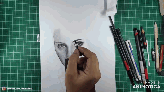 a person is drawing a woman 's face on a green cutting board