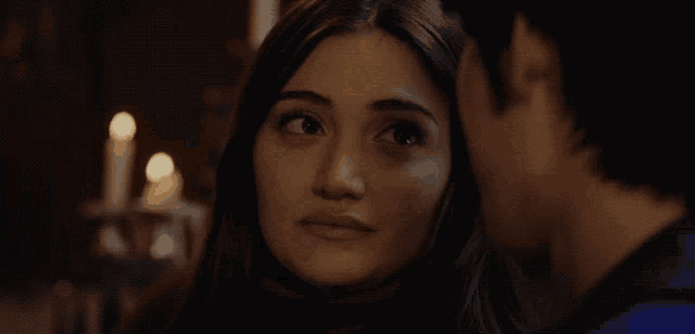 a man and a woman are looking at each other
