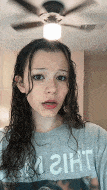 a girl wearing a gray shirt that says girl