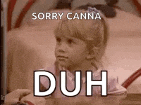 a little girl is sitting on a bed with the words `` sorry canna duh '' written above her .