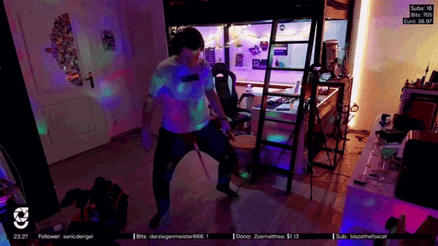 a man is dancing in a room with a sign that says subx 16 on it