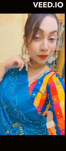 a woman in a blue and yellow striped dress with the word veed.io at the bottom