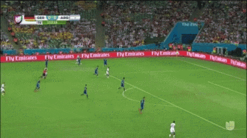 a soccer game is being played in a stadium with fly emirates ads on the sidelines