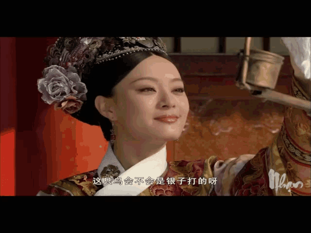 a woman wearing a crown and a flower in her hair is smiling