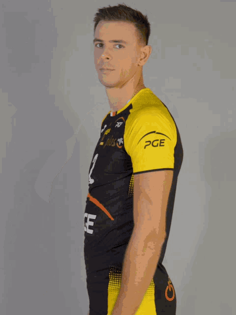 a man wearing a yellow and black jersey with the number 1 on it