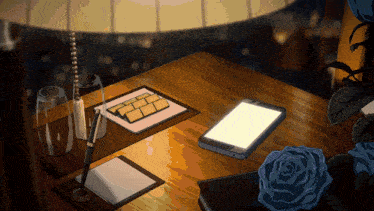 a table with a lamp a cell phone a pen and a notebook