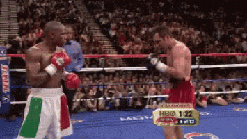 two boxers in a boxing ring with a hbo advertisement in the background