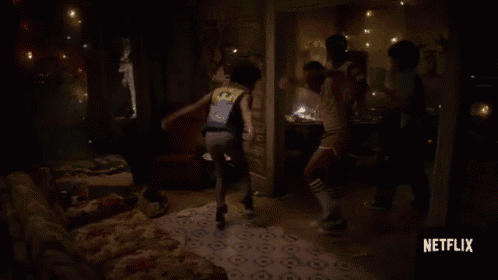 a group of people are dancing in a dark room with a netflix logo on the bottom