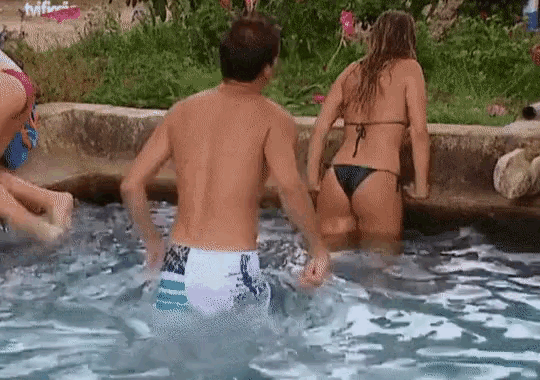 a man and a woman in a bikini are standing in a pool with the tvf logo visible
