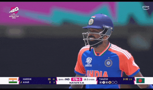 a man wearing a helmet and a blue shirt that says india on it
