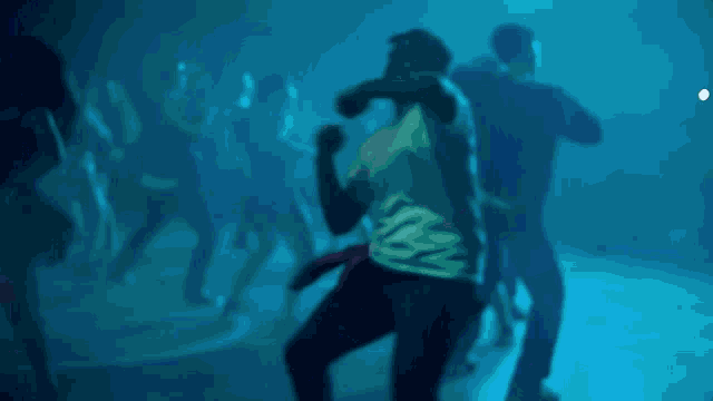 a man in a white shirt is dancing in front of a purple background