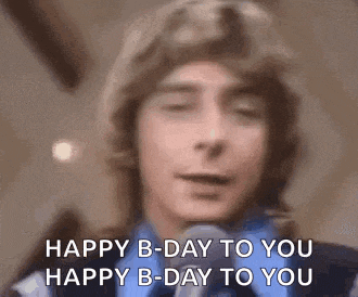 a man is singing into a microphone and saying happy b-day to you .