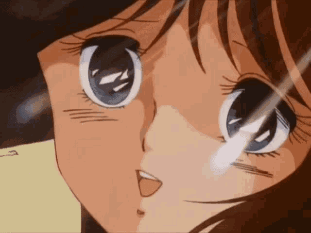 a close up of a girl 's face with blue eyes and a red mouth .