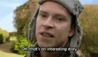 a man is wearing a hat and scarf and saying `` ok , that 's an interesting story . ''