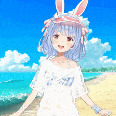 a girl with bunny ears is standing on a beach wearing a white shirt that says t-shirt