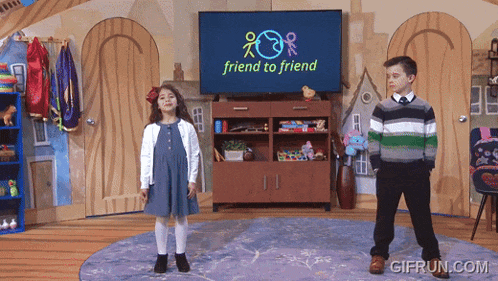 a boy and a girl are standing in front of a television screen that says friend to friend