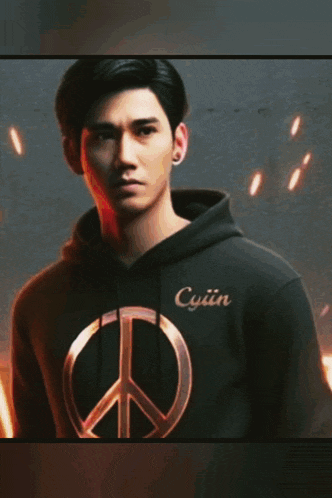 a man wearing a black hoodie with hati hati written on the bottom