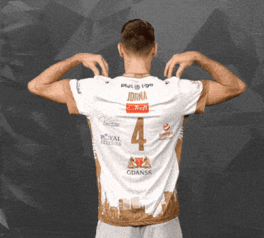 a man is wearing a jersey with the number 4 on the back