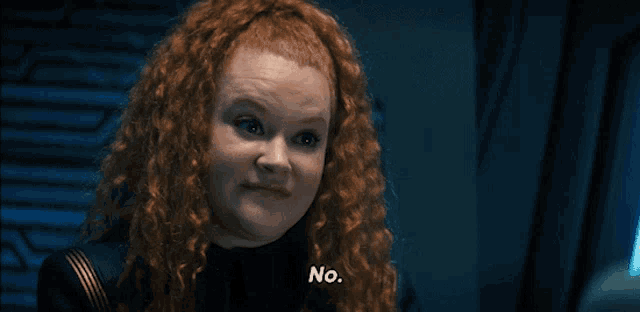 a woman with red hair is saying no