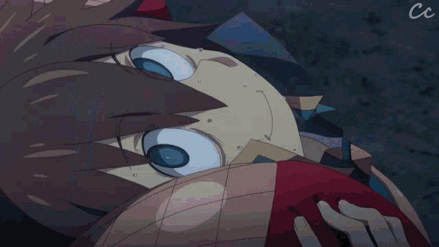 a close up of a person 's face with the letters cc visible