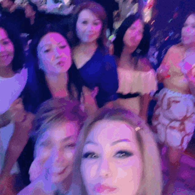 a group of women are posing for a selfie together