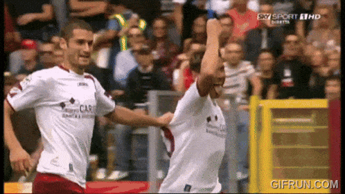 two soccer players are celebrating a goal on sky sport