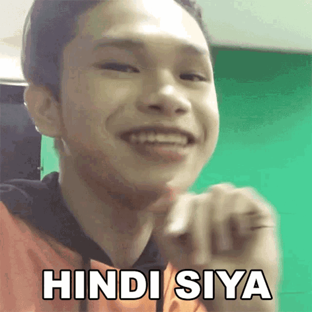 a young man is smiling and has the word hindi siya written on his face
