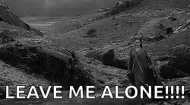 a black and white photo of a man walking down a path with the words `` leave me alone '' written on it .
