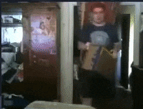 a blurry picture of a man in a room with a poster on the wall that says ' a ' on it