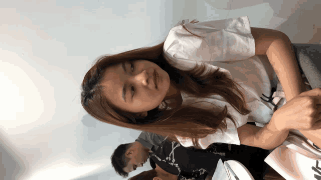 a woman wearing a white shirt with the letter a on it