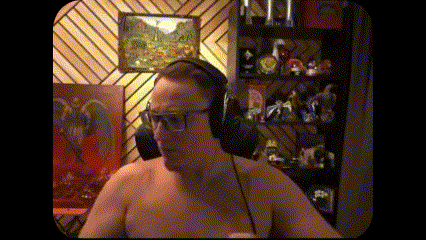 a shirtless man wearing headphones and glasses is standing in front of a shelf filled with toys .