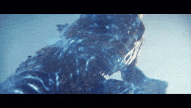 a close up of a statue of a creature in the water