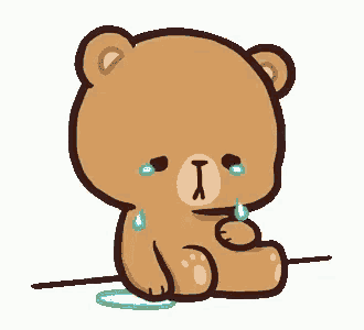 a brown teddy bear is sitting on the ground and crying .
