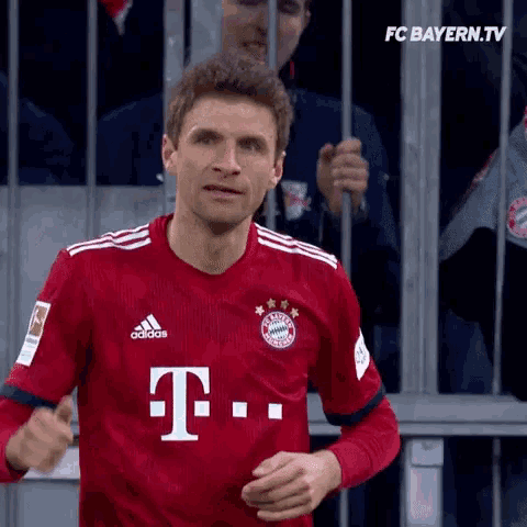 a soccer player wearing a red t-mobile shirt