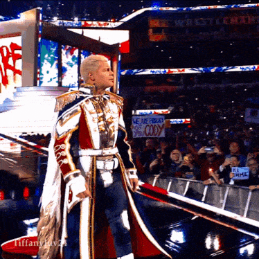 a wrestler with a sign that says " we are proud cody "