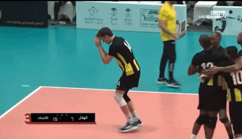 a group of volleyball players are celebrating a point during a game