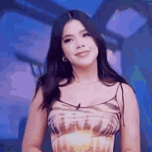 a woman is standing in front of a blue background wearing a zebra print dress .