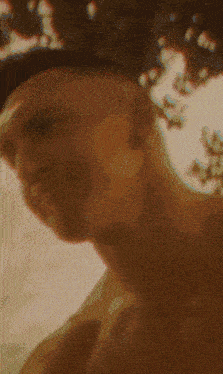 a close up of a person 's face with a blurred background