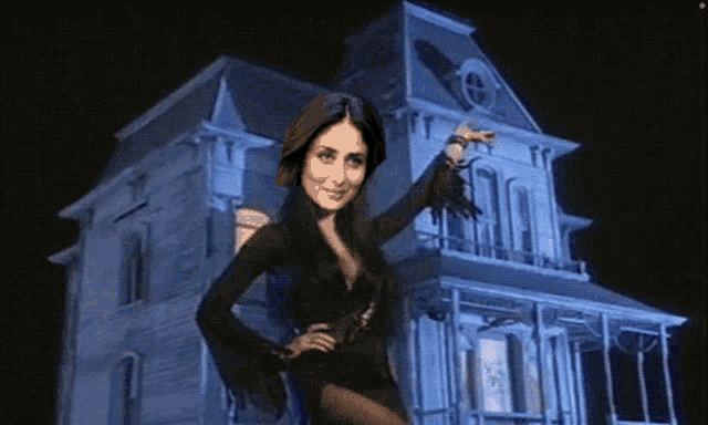 a woman standing in front of a haunted house