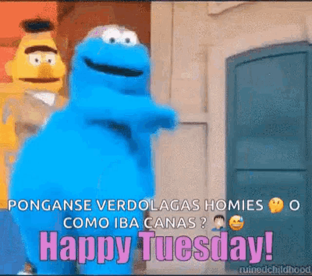 a cookie monster is standing in front of a door with the words `` happy tuesday '' written on it .