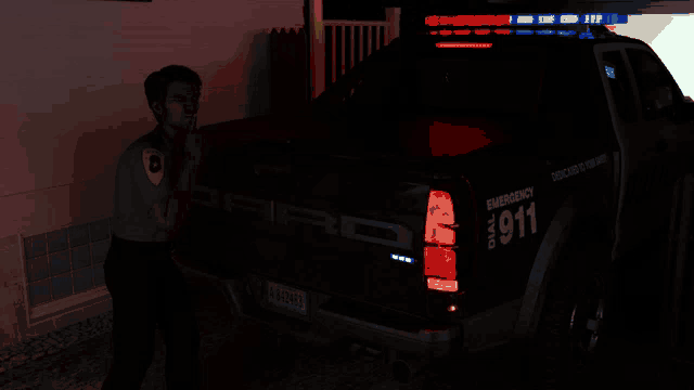 a police officer stands in front of a ford raptor