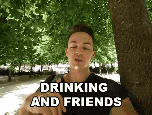 a young man leaning against a tree with the words drinking and friends written below him