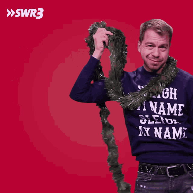 a man is wearing a sweater that says sleigh mixame