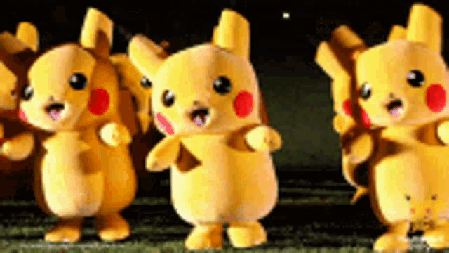 a group of pikachu mascots are dancing in a line