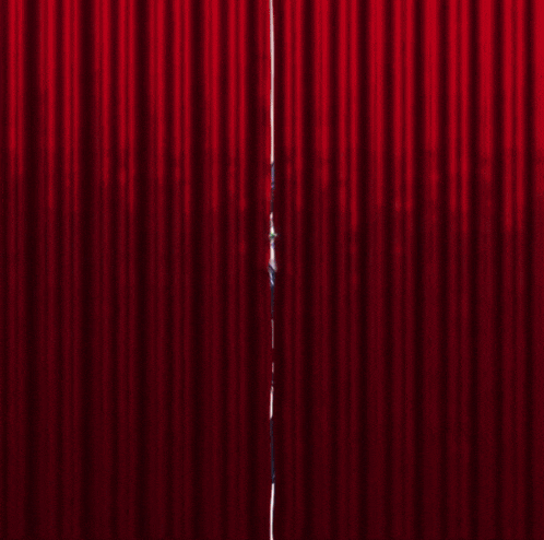 a red curtain with a girl behind it